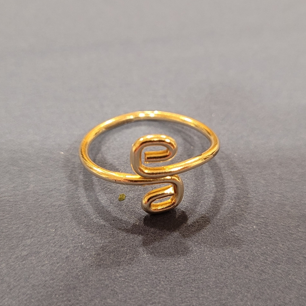 Gold colored swirl ring